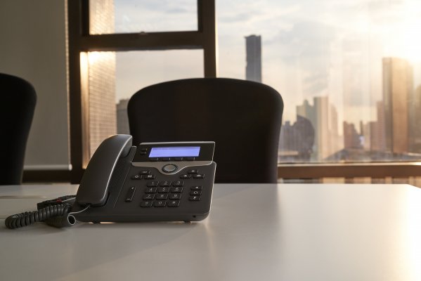 voip services phone.com desk chair window office phone on desk